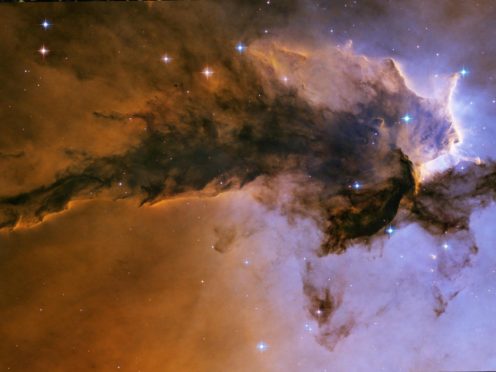 Icy grains, responsible for spectacular structures like the Eagle Nebula, help in the formation of new stars and planets (Nasa/PA)