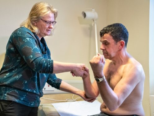 Prof Zosia Miedzybrodzka with patient Sandy Patience (University of Aberdeen/PA)