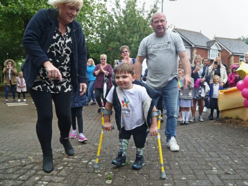 Tony Hudgell, who uses prosthetic legs, takes the final steps in his fundraising walk (Gareth Fuller/PA)