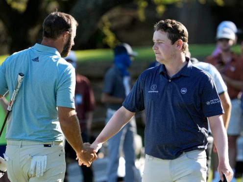 Dustin Johnson shakes hands with Robert MacIntyre after halving their match in the WGC-Dell Technologies Match Play (David J. Phillip/AP)