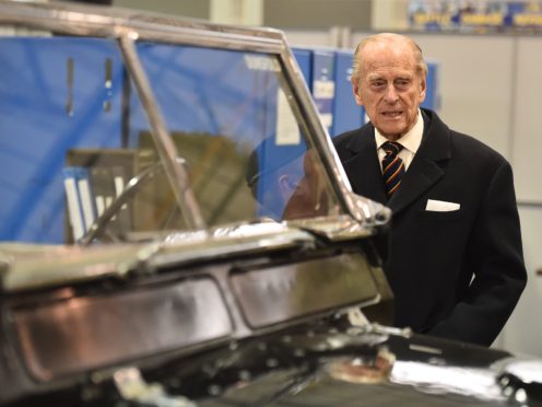 The Duke of Edinburgh looks at a Black 1960s ceremonial Land Rover Series 2A Escort Rover formally owned by The Queen Mother (Ben Stansall/PA)
