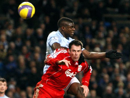 Manchester City‘s Micah Richards and Liverpool’s Jamie Carragher battle for the ball (Dave Thompson/PA)