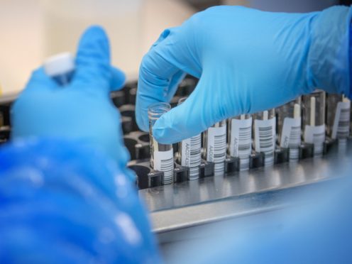 A major coronavirus testing firm is to halve the cost of PCR tests for travellers returning to the UK from overseas (Jane Barlow/PA)