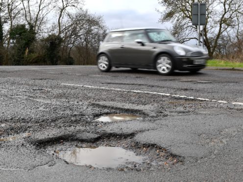 File photo dated 04/04/18 of a pothole in Cambridgeshire. Pothole-plagued local roads are the UK’s most widespread motoring concern, a new survey suggests.