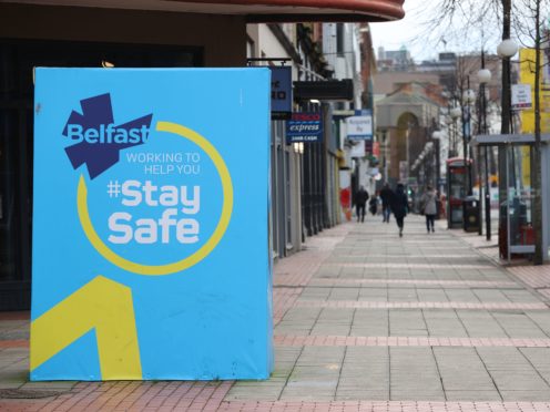 A public information sign on an empty street in Belfast (Liam McBurney/PA)