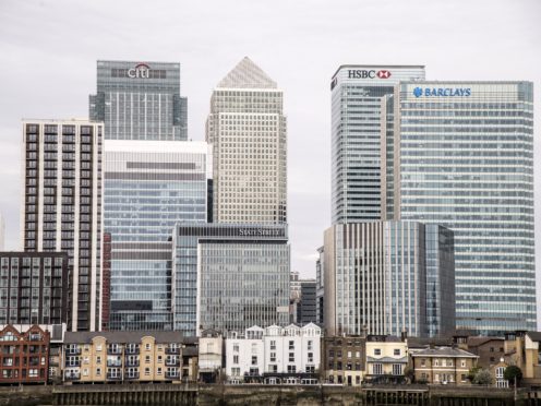 The FTSE 100 closed down slightly, failing to maintain post-Covid highs from Friday (Ian West/PA)