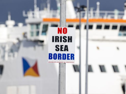 A sign on a lamp post outside Larne Port with the word ‘No Irish Sea Border’ (Liam McBurney/PA)