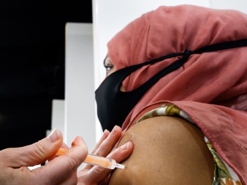 A woman receives an injection of the the Oxford/AstraZeneca coronavirus vaccine (Danny Lawson/PA)