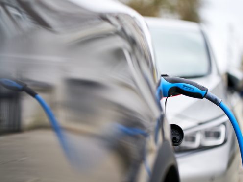 File photo dated 05/03/21 of an electric car charging. The UK is halfway to cutting its greenhouse gas emissions to net zero after a record annual fall in pollution during the pandemic, analysis shows.
