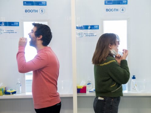 Members and employees of the English National Opera take part in the Covid-19 rapid screening programme using government-supplied lateral flow tests (Ian West/PA)