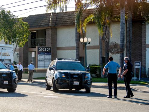 Officials work outside the scene of a shooting in Orange, California (Paul Bersebach/The Orange County Register via AP)