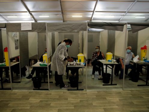 Patients receive Pfizer and Moderna’s Covid-19 vaccine in a vaccination site in Sarcelles, outside Paris (AP/Christophe Ena)