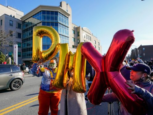 Fans hold up DMX balloons during a prayer vigil outside of White Plains Hospital (Mary Altaffer/AP)