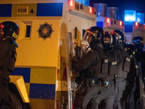 PSNI Tactical Support Group officers at the loyalist Nelson Drive Estate in Londonderry, during a public order incident in which a car was set alight (Liam McBurney/PA)
