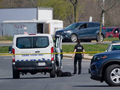 A crime scene technician stands near the scene of a shooting at a business park in Frederick, Maryland (Julio Cortez/AP)