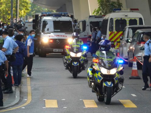 Police officers escort a prison van carrying Hong Kong pro-democracy activist Andy Li as it is leaving court in Hong Kong (Kin Cheung/AP)