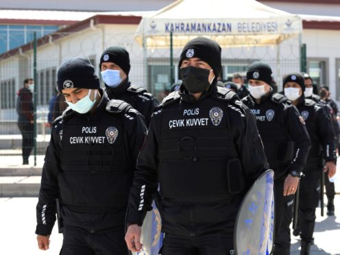 Riot police officers leave a courthouse during the trial of 497 defendants, in Sincan, outside the capital Ankara, Turkey (Burhan Ozbilici/AP)