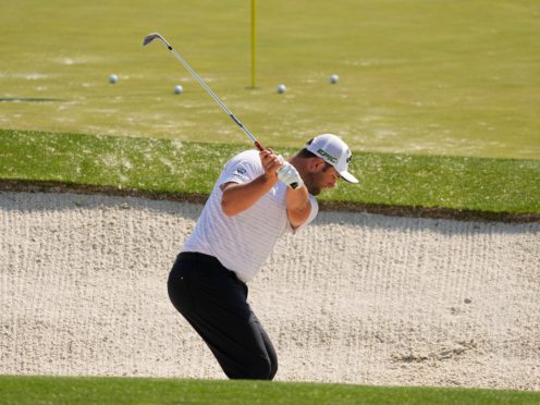 Jon Rahm hits out of a bunker at the driving range ahead of the 85th Masters (Charlie Riedel/AP)
