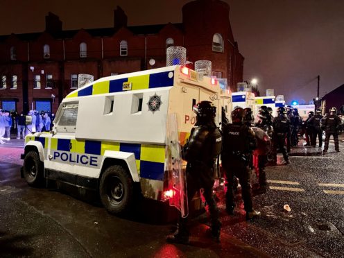 PSNI officers and Land Rovers on the nationalist side of the Springfield Road in Belfast (Liam McBurney/PA)