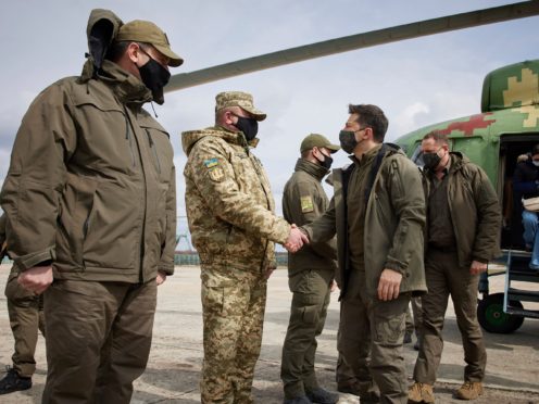 Ukrainian President Volodymyr Zelenskiy shakes hands with a soldier as he visits the war-hit Donetsk region (AP)