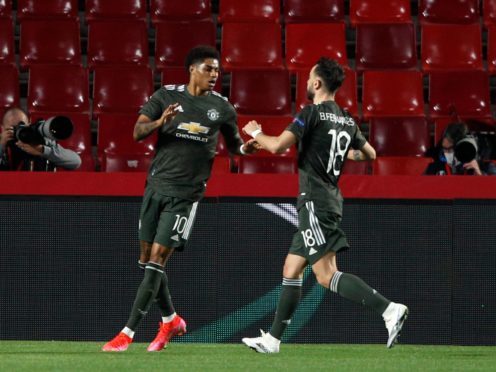 Marcus Rashford, left, celebrates the opener (Fermin Rodriguez/AP)