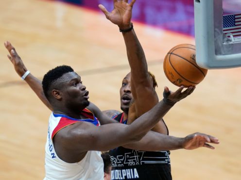 New Orleans Pelicans forward Zion Williamson drives to the basket against Philadelphia 76ers center Dwight Howard (Gerald Herbert/AP)
