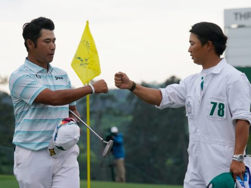 Hideki Matsuyama (left) is congratulated by his caddie Shota Hayafuji after a third-round 65 in the Masters (David J. Phillip/AP)