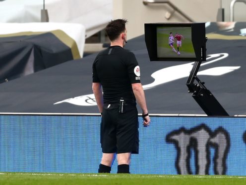 Referee Chris Kavanagh consults the pitchside monitor before ruling out Edinson Cavani’s goal (Clive Rose/PA).