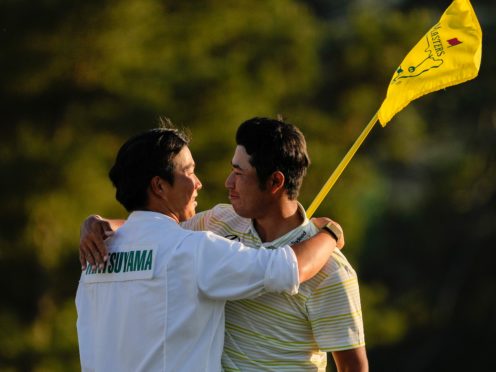 Hideki Matsuyama hugs his caddie Shota Hayafuji after winning the Masters (David J Phillip/AP)