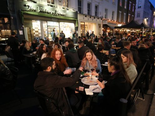People gather for drinks and food in Soho, London, on the first night of pubs and restaurants reopening in England (Jonathan Brady/PA)