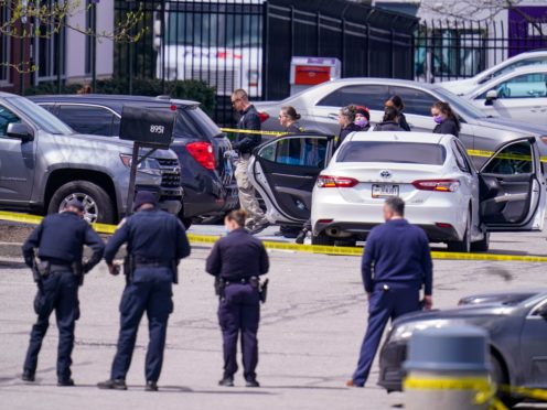 Law enforcement confer at the scene in Indianapolis (Michael Conroy/AP)