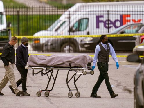 A body is taken from the scene (Michael Conroy/AP)