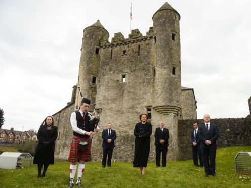 Northern Ireland’s First Minister Arlene Foster, along with Deborah Erskime, Piper Aaron Elliott, Keith Elliott, Cllr Errol Thompson, Cllr Mark Buchanan and Cllr Paul Robinson, observes a minute’s silence to mark the funeral of the Duke of Edinburgh at Enniskillen Castle, Co Fermanagh (Mark Marlow/PA)