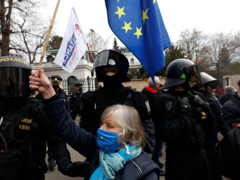 A woman waves a European Union flag in front of the Russian embassy in Prague, Czech Republic (Petr David Josek/AP)