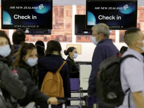 Passengers prepare at Sydney Airport to catch a flight to New Zealand as the much-anticipated travel bubble between Australia and New Zealand opens (Rick Rycroft/AP)