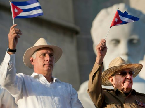 Raul Castro, right, raises the hand of Cuban President Miguel Diaz-Canel after he was elected First Secretary of the Communist Party at the closing session of Cuban Communist Party’s 8th Congress at the Convention Palace in Havana, Cuba (Ariel Ley Royero/ACN via AP)