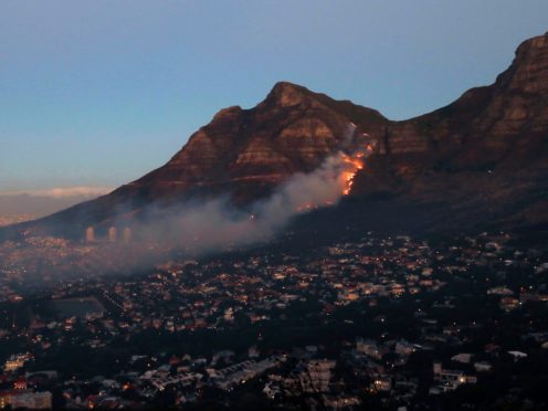 Fire burns on the slopes of Table Mountain in Cape Town, South Africa, Monday, April 19, 2021. People were evacuated from Cape Town neighbourhoods as a raging wildfire sweeping across the slopes of the city’s famed Table Mountain was fanned by high winds and threatened homes. City authorities said the fire, which started early Sunday, was still not under control. The blaze has already burned the library and other buildings on the campus of the University of Cape Town. (AP Photo/Nardus Engelbrecht)