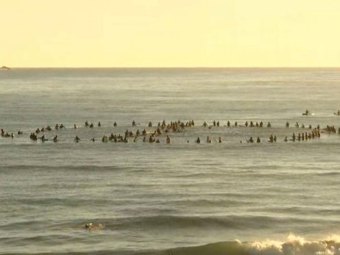 Surfers form a cancel symbol in the water off Byron Bay (Australian Broadcasting Corporation via AP)