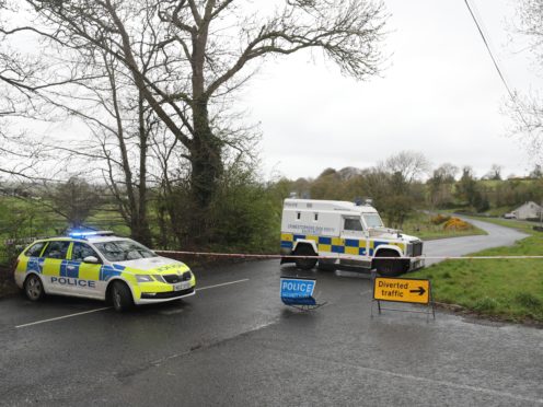 PSNI vehicles block a road near the scene of the incident (Niall Carson/PA)