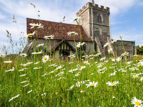 St John’s Church Duxford with wildflowers in the foreground (Adrian Powter/Church of England/PA)