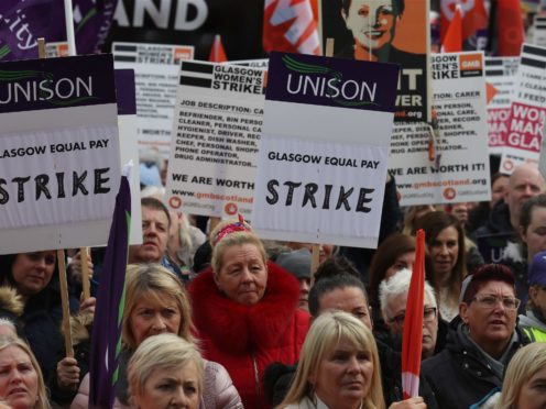 Strikers outside Glasgow Council’s city chambers in George Square (PA)