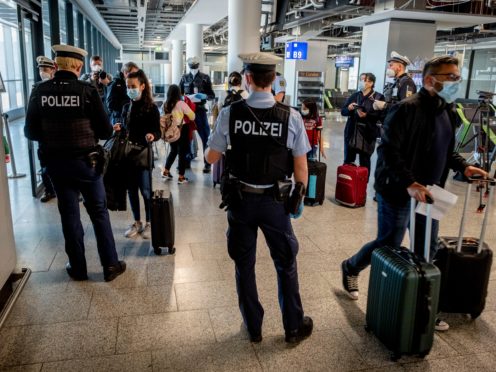 German police check passengers arriving from Mallorca for a negative Covid test as they arrive in Frankfurt (Michael Probst/AP)