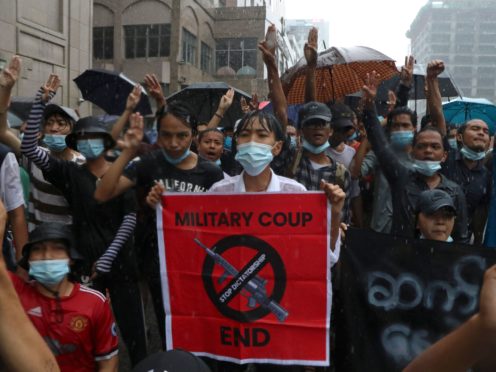 Protesters flash the three-finger salute during another demonstration against Myanmar’s military coup in Yangon on Friday (Vincent Thian/AP)
