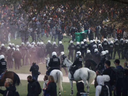 Police attempt to disperse gatherers at the Bois de la Cambre park during a party called “La Boum 2” in Brussels, Saturday, May 1, 2021. Police put on extra patrols Saturday to monitor the gathering which is being held in defiance of Belgium’s current COVID-19 regulations. (AP Photo/Olivier Matthys)