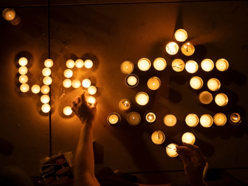 People light candles in memory of the 45 ultra-Orthodox Jews killed in a stampede at a religious festival on Friday, during a candle-light vigil in Tel Aviv, Israel, Saturday, May 1, 2021. The stampede early Friday had cut short the annual festival of Lag BaOmer on Israel’s Mount Meron. The festival had drawn some 100,000 people in the largest gathering. (AP Photo/Oded Balilty)