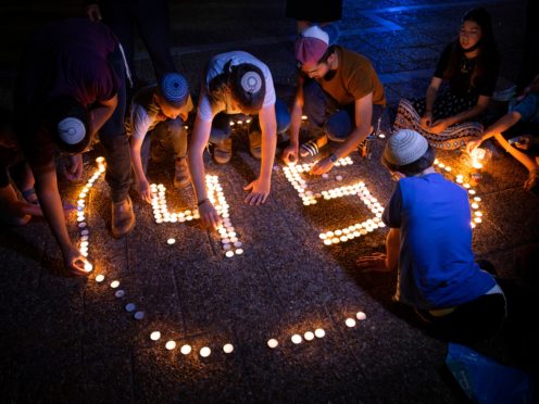 Israeli youths light candles in memory of the 45 ultra-Orthodox Jews killed in a stampede at a religious festival on Friday, during a vigil in Tel Aviv, Israel (Oded Balilty/AP)