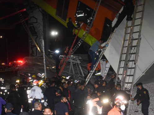 Firefighters and rescue personnel working at the scene (Jose Ruiz/AP)
