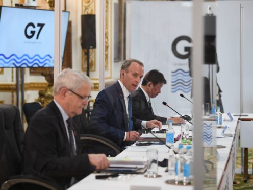 Foreign Secretary Dominic Raab sits between the Canadian minister of foreign affairs Marc Garneau and Japanese minister of foreign affairs Motegi Toshimitsu, during talks at the G7 Foreign and Development Ministers meeting at Lancaster House in London (PA)