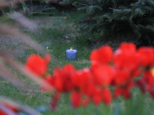 A lit candle marks one week since the death of PCSO Julia James (Gareth Fuller/PA)