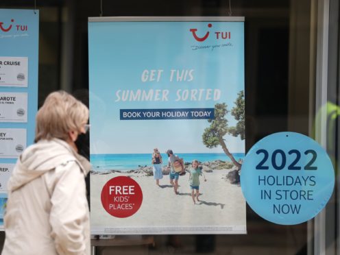 A person makes their way past the shop window of a Tui store in Eastleigh, Hampshire (Andrew Matthews/PA)